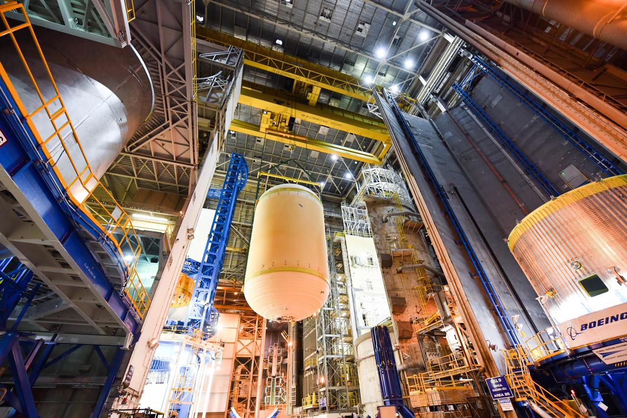 The Space Launch System (SLS) rocket’s liquid oxygen tank structural test article was manufactured and stacked in June 2019 at NASA’s Michoud Assembly Facility in New Orleans. To construct the test article, Boeing technicians at Michoud moved the liquid oxygen tank to the Vertical Assemby Building stacking and integration area. Here, they added simulators to mimic the two structures that connect to the tank, the intertank and the forward skirt.  This structural hardware for the SLS core stage for America’s new deep space rocket is structurally identical to the flight version of the tank. It will be shipped on the Pegasus barge to NASA’s Marshall Space Flight Center in Hunstville, Alabama, where it will undergo a series of tests that simulate the stresses and loads of liftoff and flight. These tests will help ensure designs are adequate for successful SLS missions to the Moon and beyond. The flight liquid oxygen tank along with the liquid hydrogen tank supplies more than 500,000 gallons of propellant to the core stages four RS-25 engines, which produce 2 million pounds of thrust to help send the SLS rocket to space.